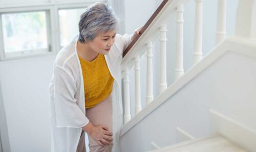 Woman walking carefully up stairs