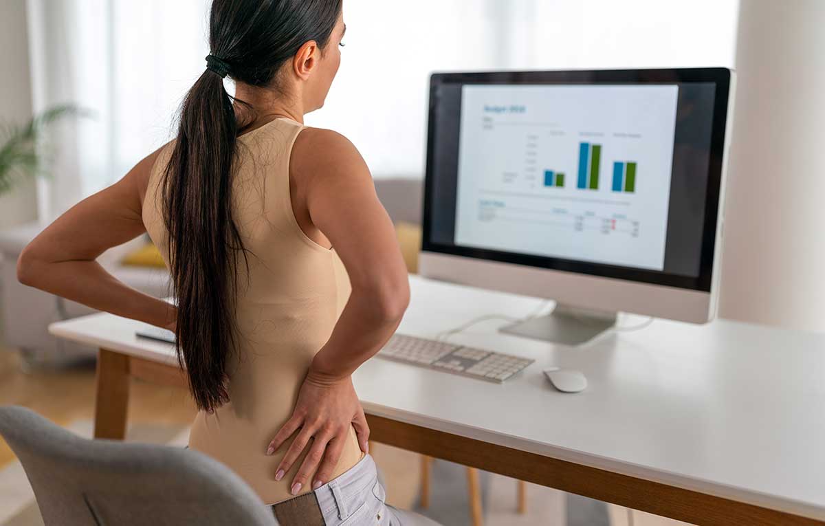 Woman with back pain at workstation
