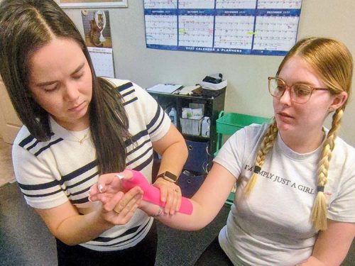 Emily fitting an orthotic for a patient