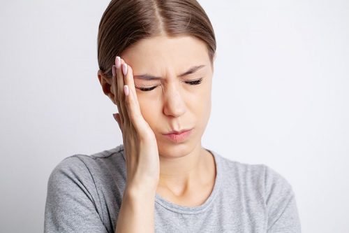 Woman with TMD suffers from headache