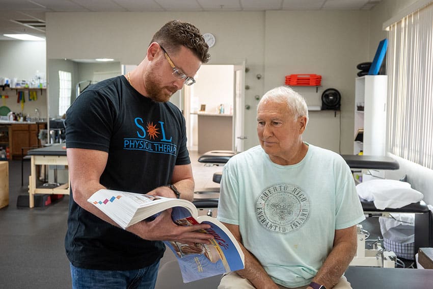 Therapist educating patient on fall prevention
