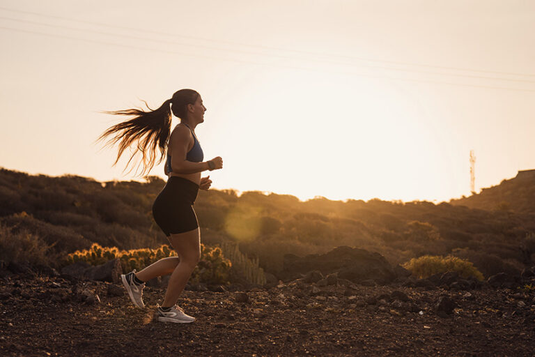 Young Woman Running at Sunrise